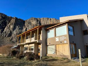 a building with a mountain in the background at Chaltén Mountain Lofts 1 in El Chalten +6 photos