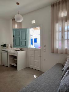 a bedroom with a bed and a sink and a counter at ARK Tinos in Agios Ioannis Tinos