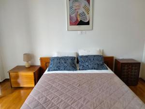 a bedroom with a large bed with blue pillows at AcropolisCozyStay in Athens