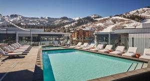 a swimming pool with lounge chairs and a resort at Pendry Park City in Park City