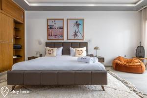 a bedroom with a large bed with white sheets and pillows at Stayhere Agadir - Ocean View Residence in Agadir