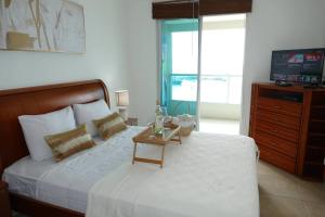 a bedroom with a bed with a table on it at Ecusuites Playa Privada Piscina Jacuzzi 7B- a 10 min Salinas in Salinas