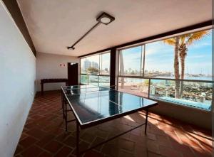a glass table in a room with a view of the ocean at Ecusuites Playa Privada Piscina Jacuzzi 7B- a 10 min Salinas in Salinas