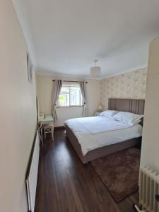 a bedroom with a bed and a window at Brielle House in Mountmellick