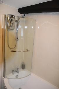 a bathroom with a shower and a sink at Sweetbriar Cottage Bed & Breakfast and Camping in Starbotton