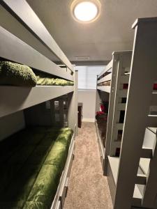 a hallway with bunk beds in a room at Sunshine Cabin in Crestline