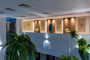 a lobby with a waiting area with plants at Leonardo Boutique Hotel Larnaca in Larnaca