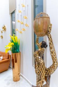 a statue of a woman holding a basket at Leonardo Boutique Hotel Larnaca in Larnaca