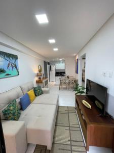 a living room with a couch and a tv at Mardisa Design by Jess Hospedagens in João Pessoa