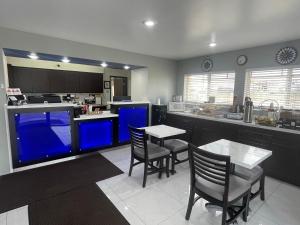 a kitchen with chairs and a table and a counter at Americas Choice Inn & Suites in Gila Bend