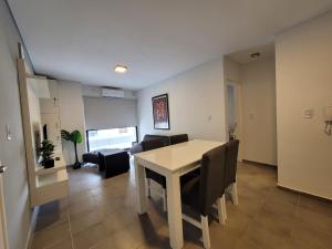 Un comedor y una sala de estar con mesa y sillas. en Departamento Céntrico muy cómodo, en San Juan