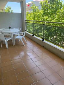 a balcony with a table and chairs and a table at MBO Michelangelo in Salou