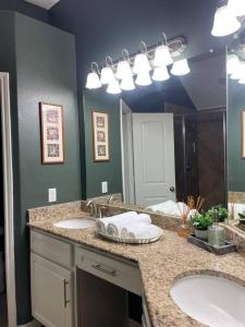 a bathroom with two sinks and a large mirror at Spacious Conroe Home around 4 miles to the Lake in Montgomery