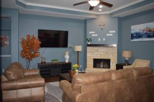 a living room with two couches and a fireplace at Spacious Conroe Home around 4 miles to the Lake in Montgomery