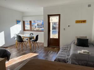 a living room with a table and a couch at Chalten Mountain Lofts 4 in El Chalten