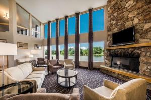 a large living room with a fireplace and a tv at Best Western Indian Oak in Chesterton