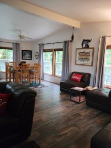 a living room with a couch and a table at A Relaxing Getaway-A Backwoods Cabin SolDuc River in Beaver