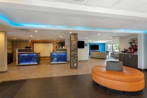 an office lobby with an orange ottoman at Best Western Plus Bowling Green in Bowling Green