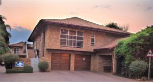 a brick house with a garage at The Monte Carlo in Centurion