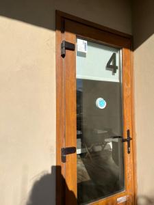 a glass door with the number four on it at Chalten Mountain Lofts 4 in El Chalten