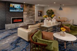 a living room with a couch and a fireplace at Best Western Plus Beckley Inn in Beckley