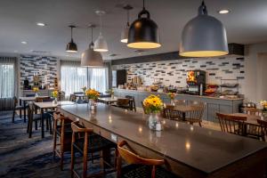 a restaurant with tables and chairs and a kitchen at Best Western Plus Beckley Inn in Beckley