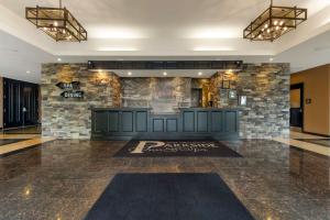 a lobby with a stone wall and blue cabinets at Best Western Plus Perth Parkside Inn & Spa in Perth