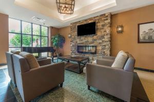 a living room with couches and a fireplace at Best Western Plus Perth Parkside Inn & Spa in Perth
