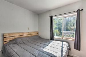 1 dormitorio con cama y ventana en Riverfront Dorena Home with Hot Tub and Game Room!, 