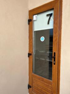 une porte en bois avec un panneau numéro 7 dans l'établissement Chalten Mountain Lofts 7, à El Chalten