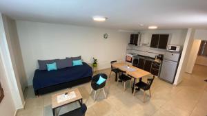 a bedroom with a bed and a table and chairs at Mirador de Alem Apartments in Ushuaia