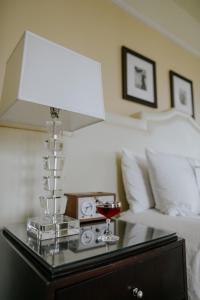a living room with a white couch and a lamp at Hotel DeLuxe, a Provenance Hotel in Portland
