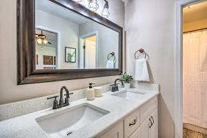 a bathroom with a sink and a mirror at Navarre Home with Game Area and Screened-In Porch in Navarre +20 photos