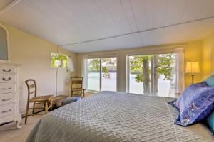 a bedroom with a bed and a window at Lakefront Cottage with Covered Porch and Dock! in Coventry