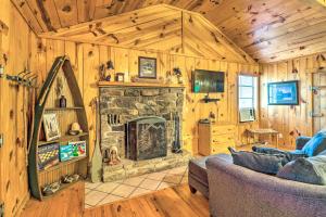 a living room with a stone fireplace in a cabin at Mountian View Retreat Less Than 2 Mi to White River! in Mountain View