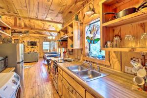 a kitchen with a sink and a wooden floor at Mountian View Retreat Less Than 2 Mi to White River! in Mountain View