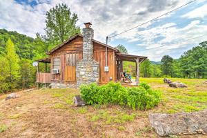a small wooden cabin with a chimney on a field at Mountian View Retreat Less Than 2 Mi to White River! in Mountain View