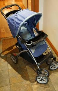 a blue baby stroller sitting on a tile floor at Luxury 1 Bedroom Unit-Walk to Beach -Baby Friendly in Los Angeles