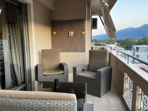 a balcony with two chairs and a couch at The Spartan Penthouse in Sparti