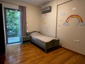 a bedroom with a bed and a rainbow on the wall at The Spartan Penthouse in Sparti