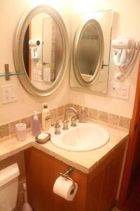 a bathroom with a sink and two mirrors at Luxury 1 Bedroom Unit-Walk to Beach -Baby Friendly in Los Angeles