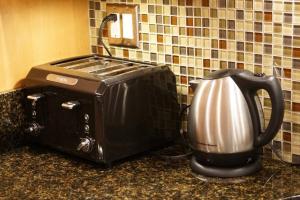 a toaster and coffee maker on a kitchen counter at Luxury 1 Bedroom Unit-Walk to Beach -Baby Friendly in Los Angeles