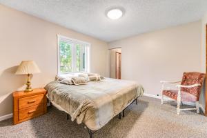 a bedroom with a bed and a chair and a window at Misty Meadow in Fraser