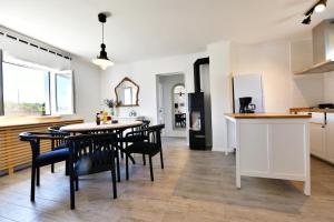a kitchen and dining room with a table and chairs at MY WAY apartman i sobe in Saborsko