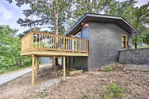 a house with a deck on the side of it at Updated Lakefront Cabin with Deck and Boat Dock! in Eucha