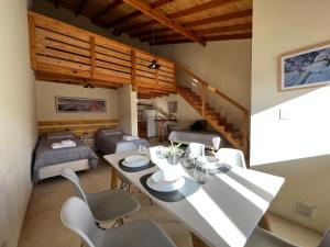 a living room with a table and chairs in a room at Chaltén Mountain Lofts 2 in El Chalten