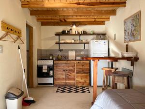 a kitchen with wooden cabinets and a counter top at Chaltén Mountain Lofts 2 in El Chalten