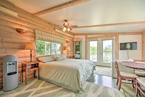 a bedroom with a bed in a room with wooden walls at Peaceful Horicon Studio with Rock River Access! in Juneau