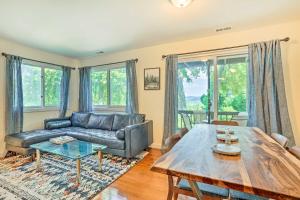 a living room with a couch and a table at Sun-Lit Vernon Condo Less Than 2 Mi to Ski Resort! in Vernon Township
