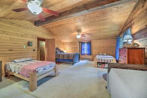 a bedroom with two beds in a log cabin at Scenic Creekside Cabin with Wraparound Porch! in Highlands